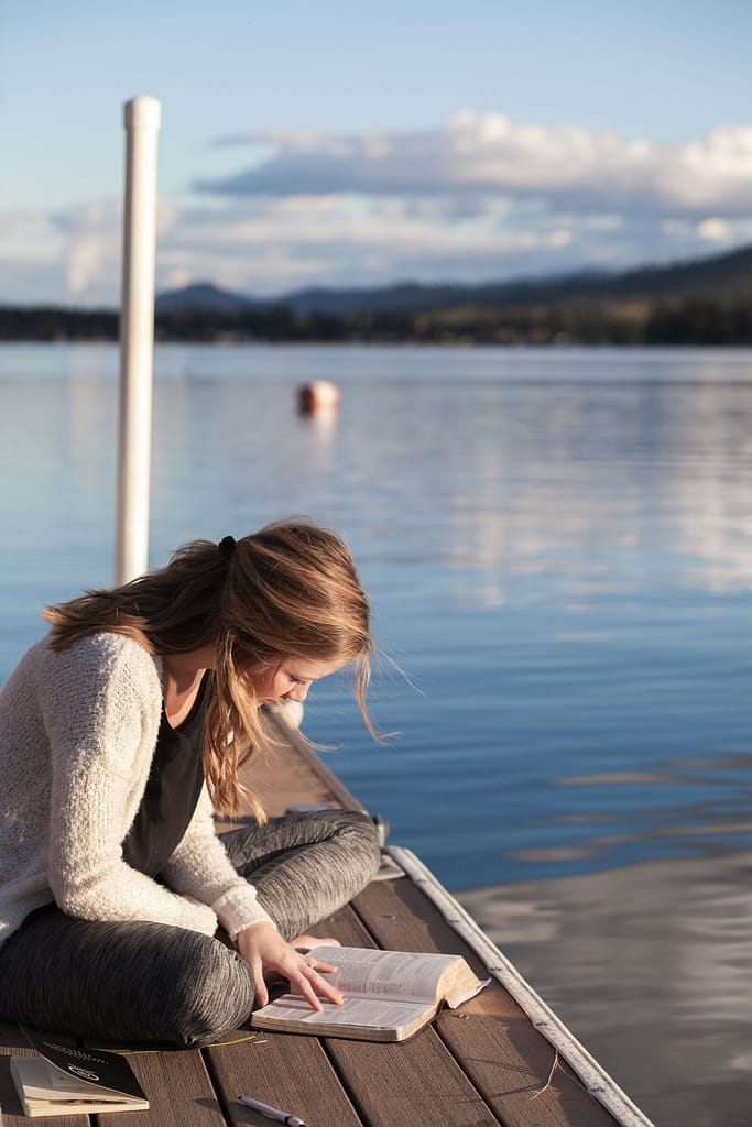 young adult woman reading a book